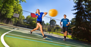 Young Woman and man playing Pickleball